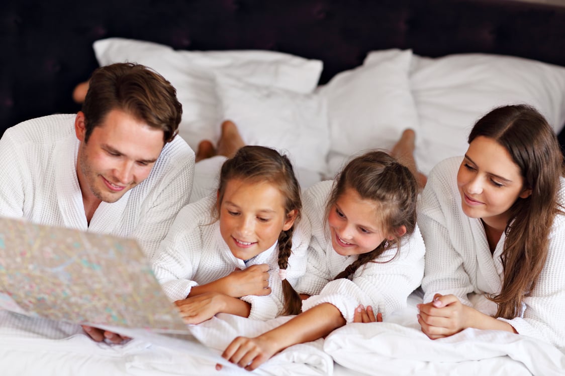 Happy Family Relaxing in Hotel Room